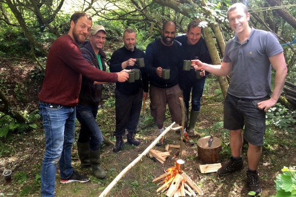 Enjoying hot drink after making fire